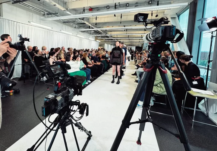 Behind the scenes of a catwalk video production supporting Milton Keynes, with cameras filming models on the runway.